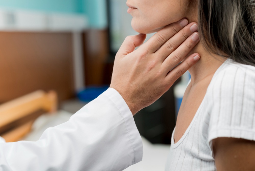 Doctor is touching touching throat of patient Doctor is touching touching throat of patient